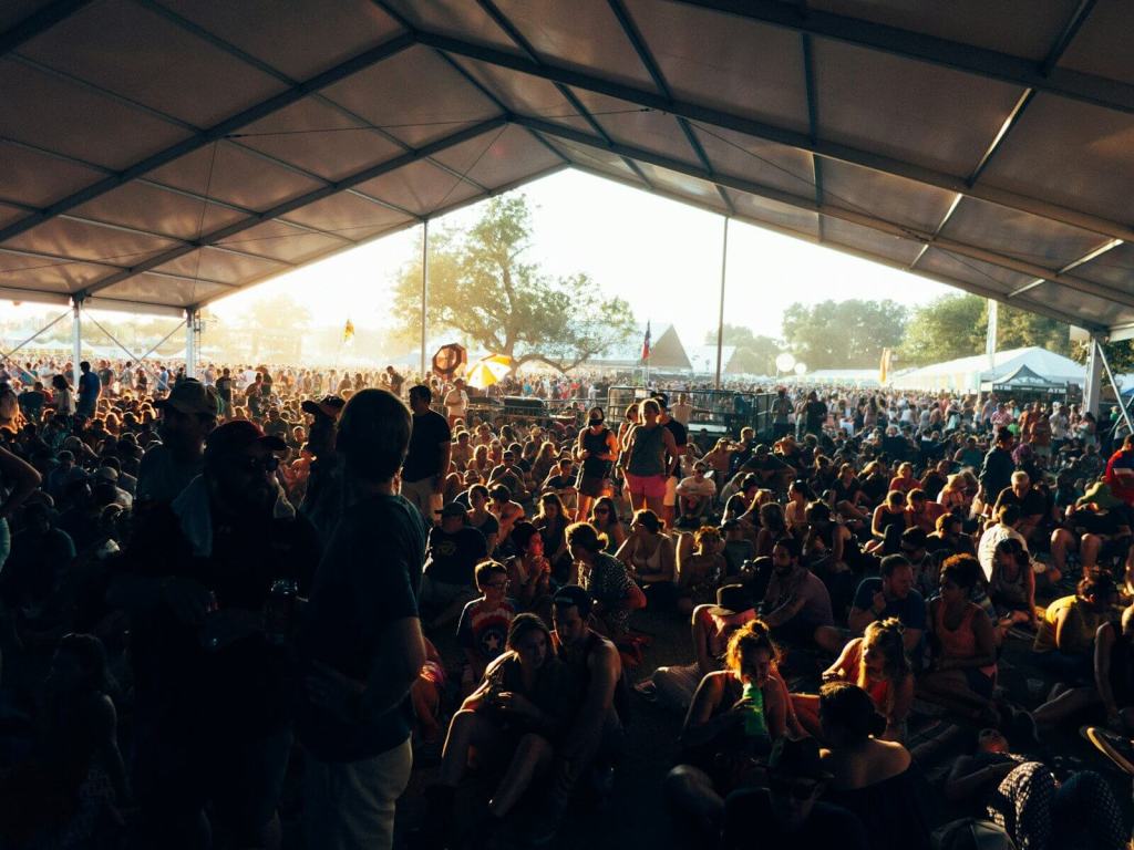 a large group of people sitting under a tent