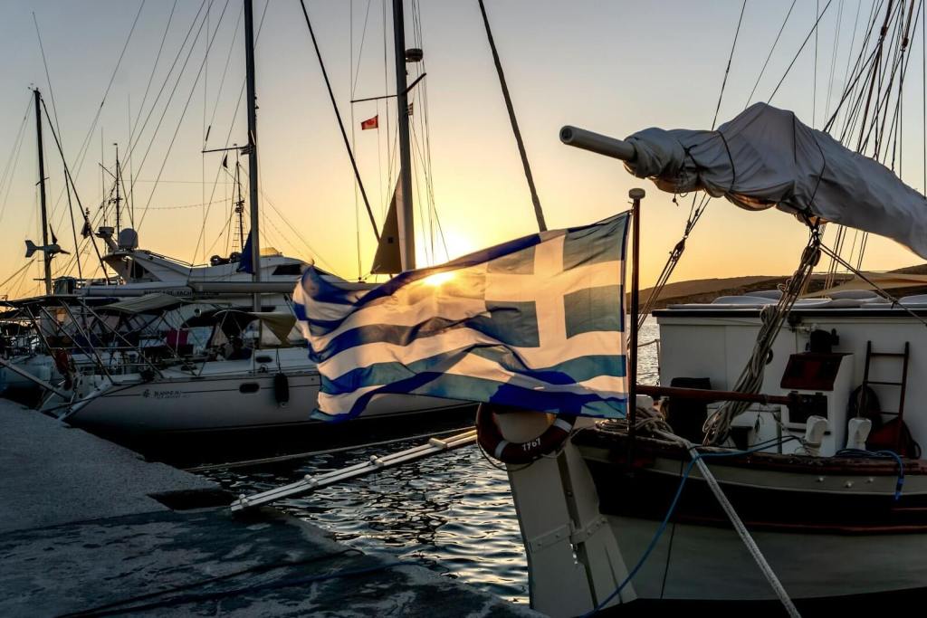 a group of sailboats sitting next to each other on a body of water