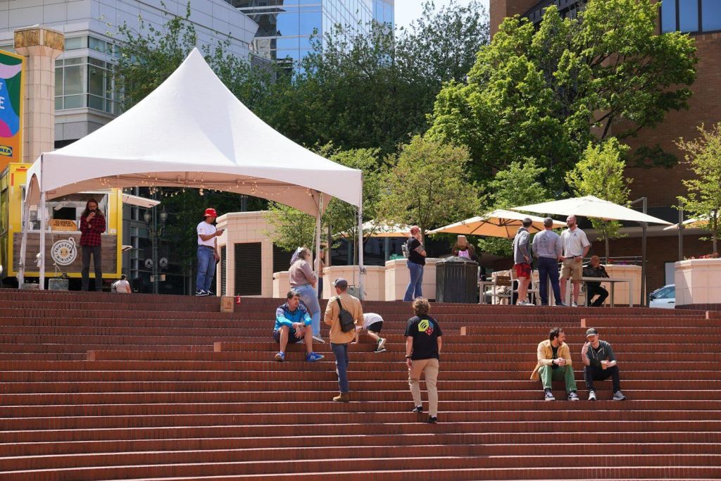 People gather outdoors on a sunny day